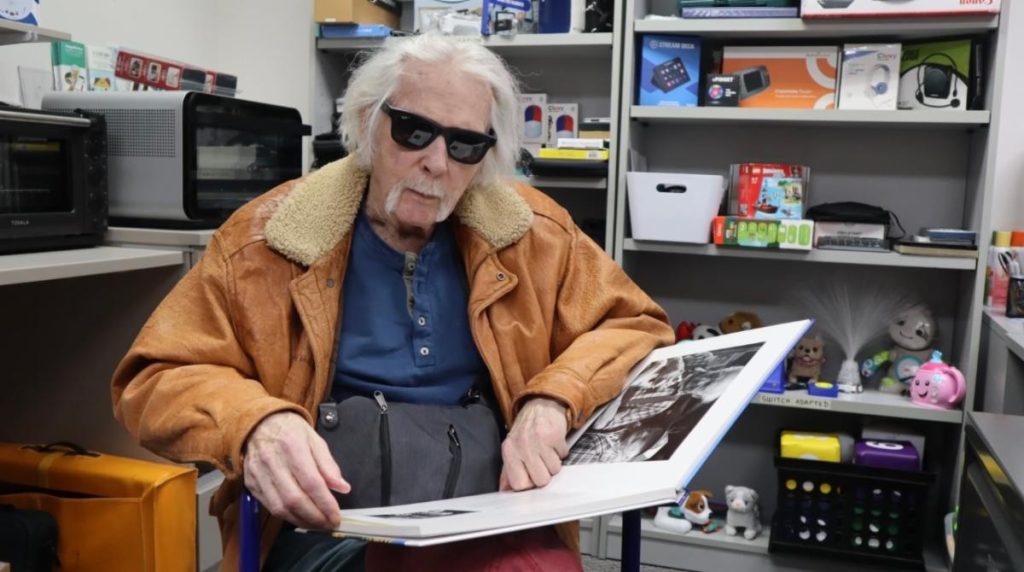Jack, reviewing photos from a book of his photography